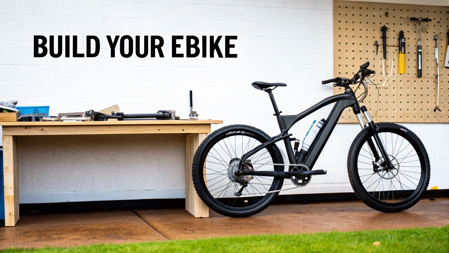 A sleek black electric bike stands beside a workbench with tools, under 'BUILD YOUR EBIKE' text.