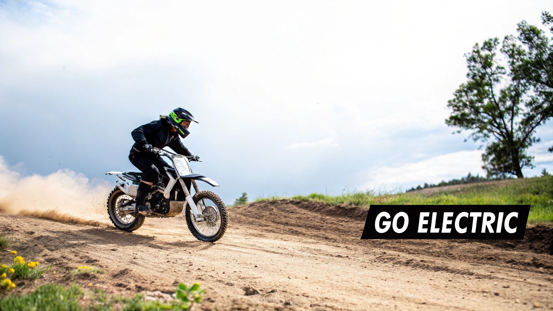 A person in black gear and helmet rides an electric dirt bike on a dusty track, kicking up soil.
