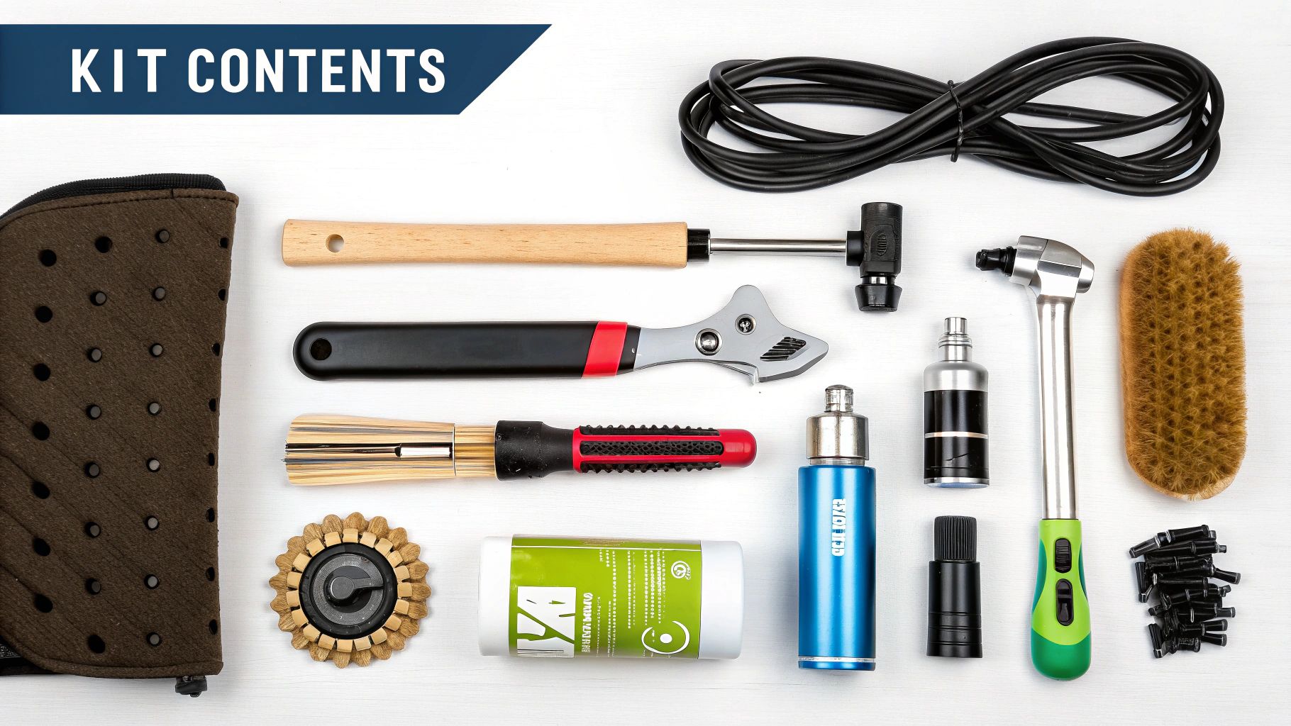 A flat lay of various tools and accessories for cycle maintenance laid out on a white surface.