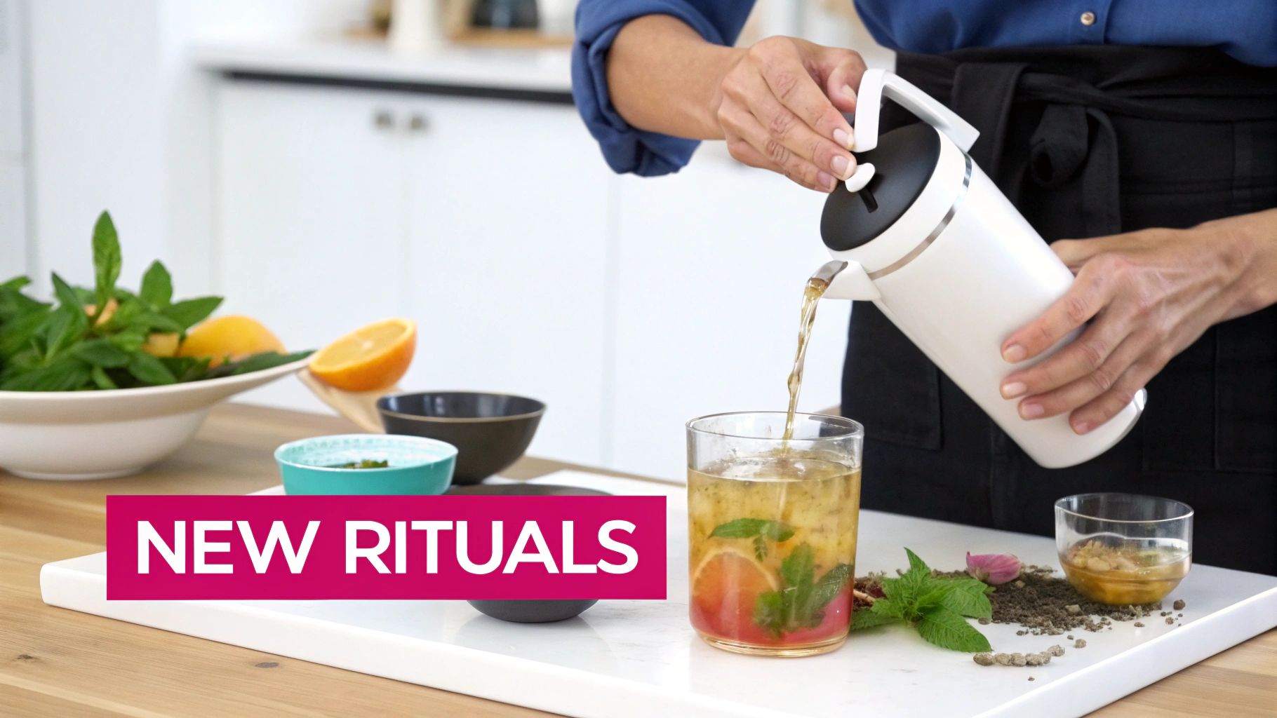A person pours a refreshing herbal drink with mint and citrus from a white carafe into a glass on a tray.