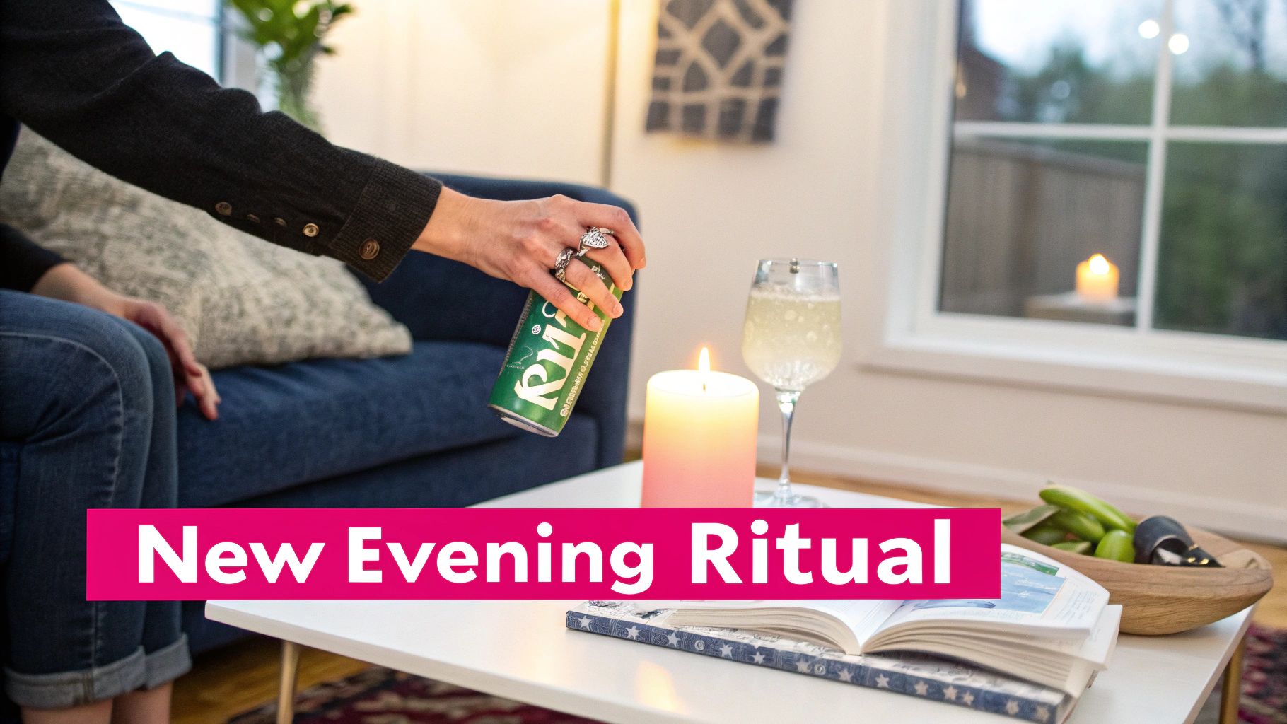 A person holds a green can next to a lit candle, a sparkling drink, and an open book, suggesting an evening ritual.