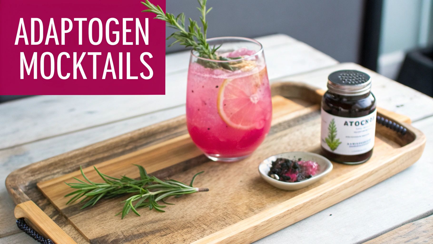 A vibrant pink adaptogen mocktail with lemon and rosemary on a wooden tray with an ATOCK 07 jar.