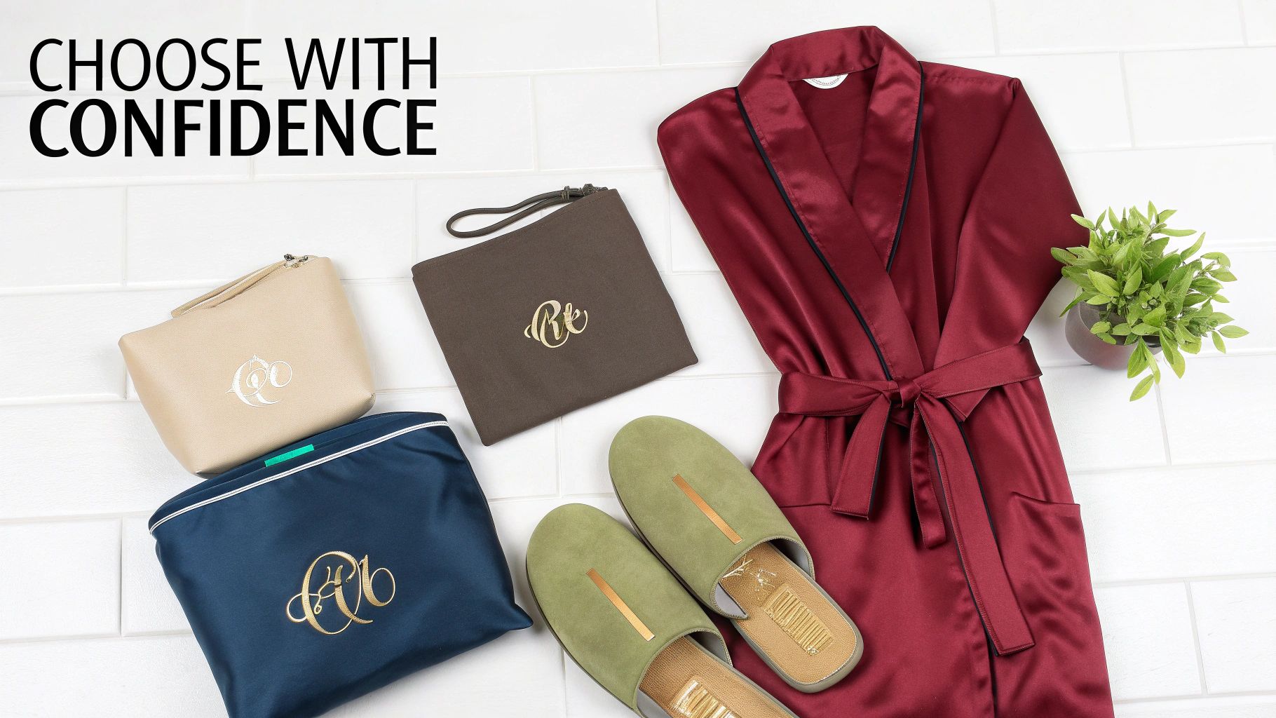 A collection of personalized luxury gifts including a red satin robe, green slippers, and monogrammed pouches.