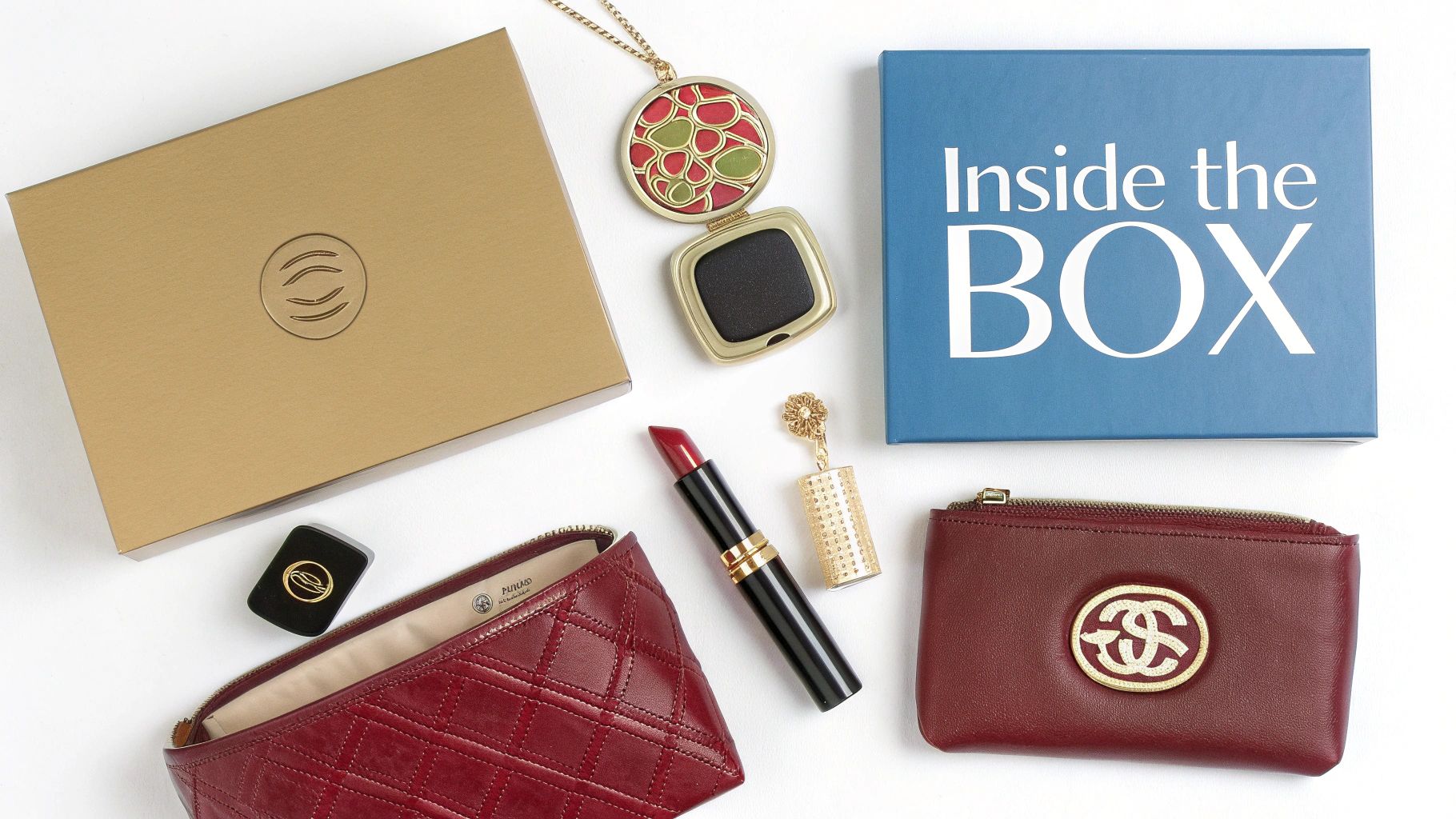 A flat lay of luxury beauty products and fashion accessories, including red pouches, lipstick, and a necklace.