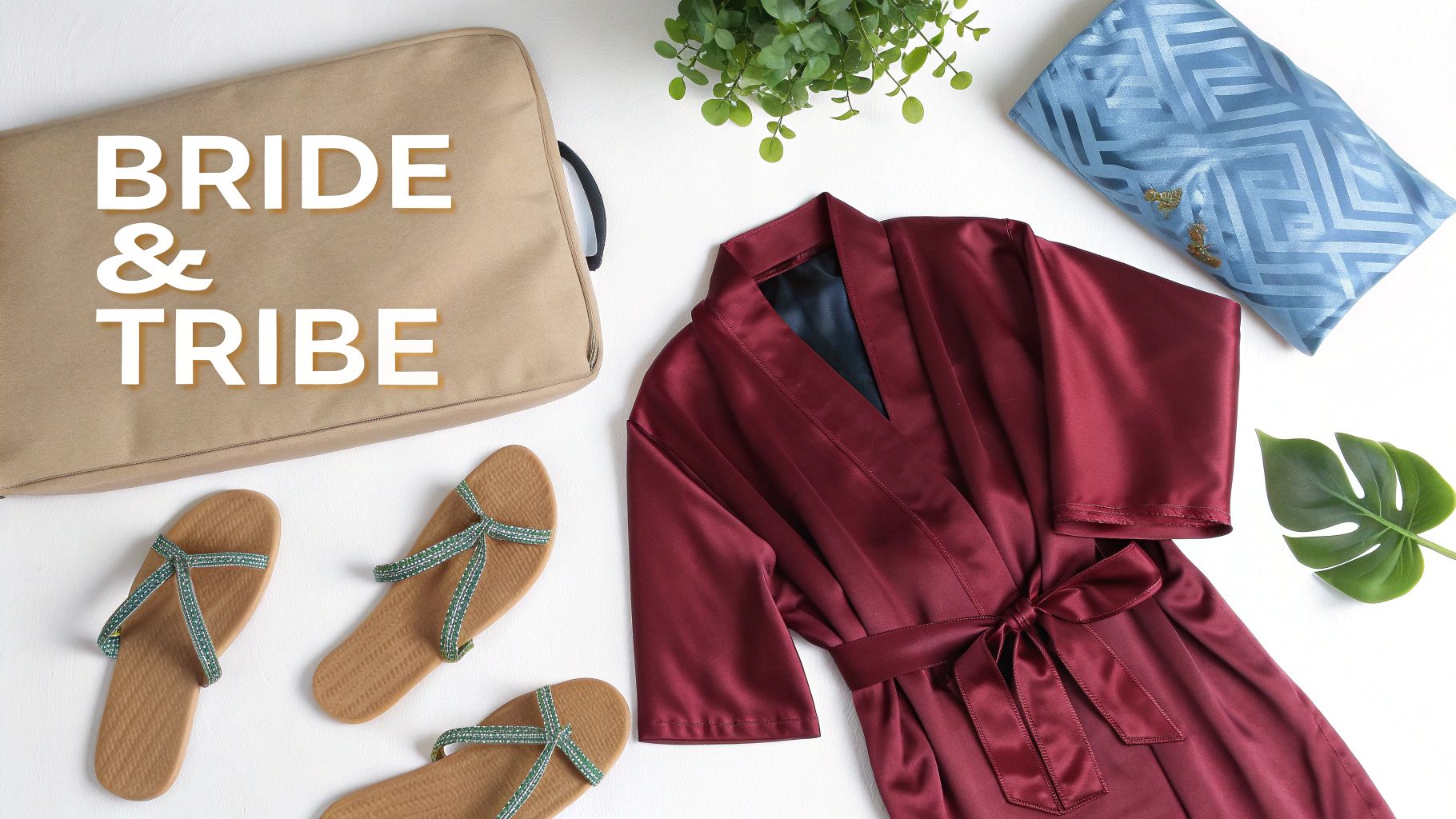 A flat lay of bride and tribe themed wedding accessories including a robe, bag, and sandals.