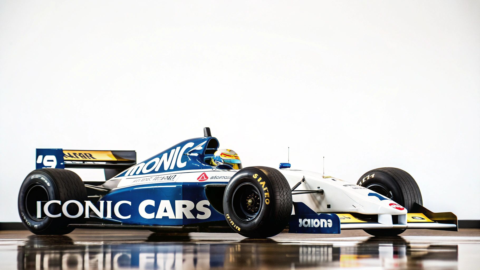 A classic blue and white Formula 1 race car, branded 'ICONIC CARS', on a white background.