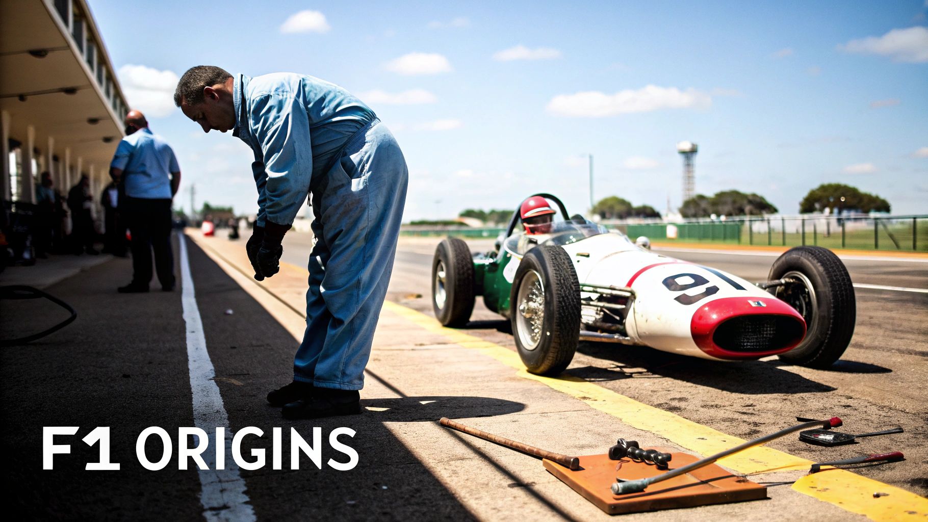 Mechanic bending near a vintage F1 race car with driver on a sunny pit lane, F1 Origins.