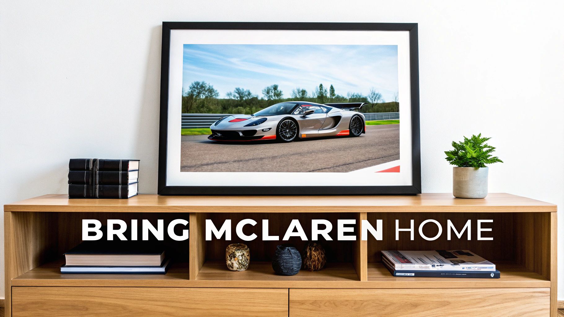A framed image of a McLaren race car on a track, with "BRING MCLAREN HOME" text.