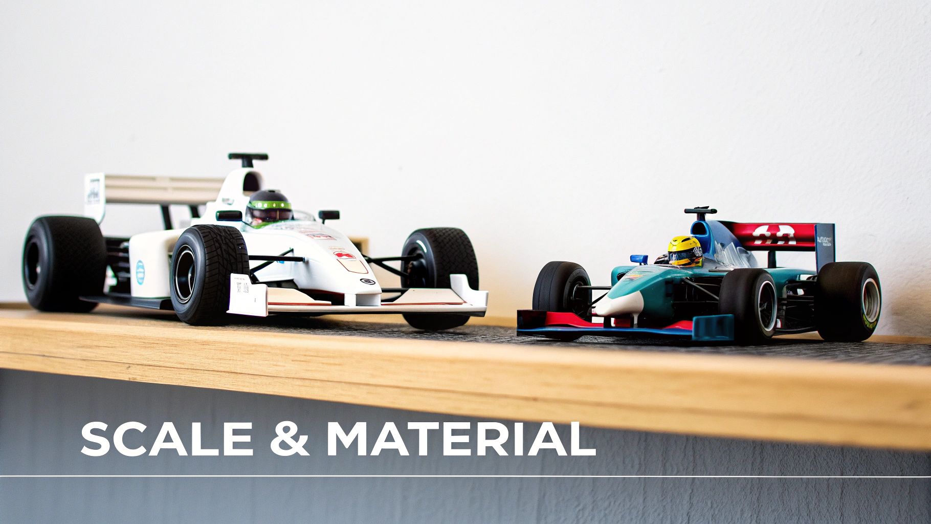 Two detailed miniature Formula One racing car models displayed on a wooden shelf.