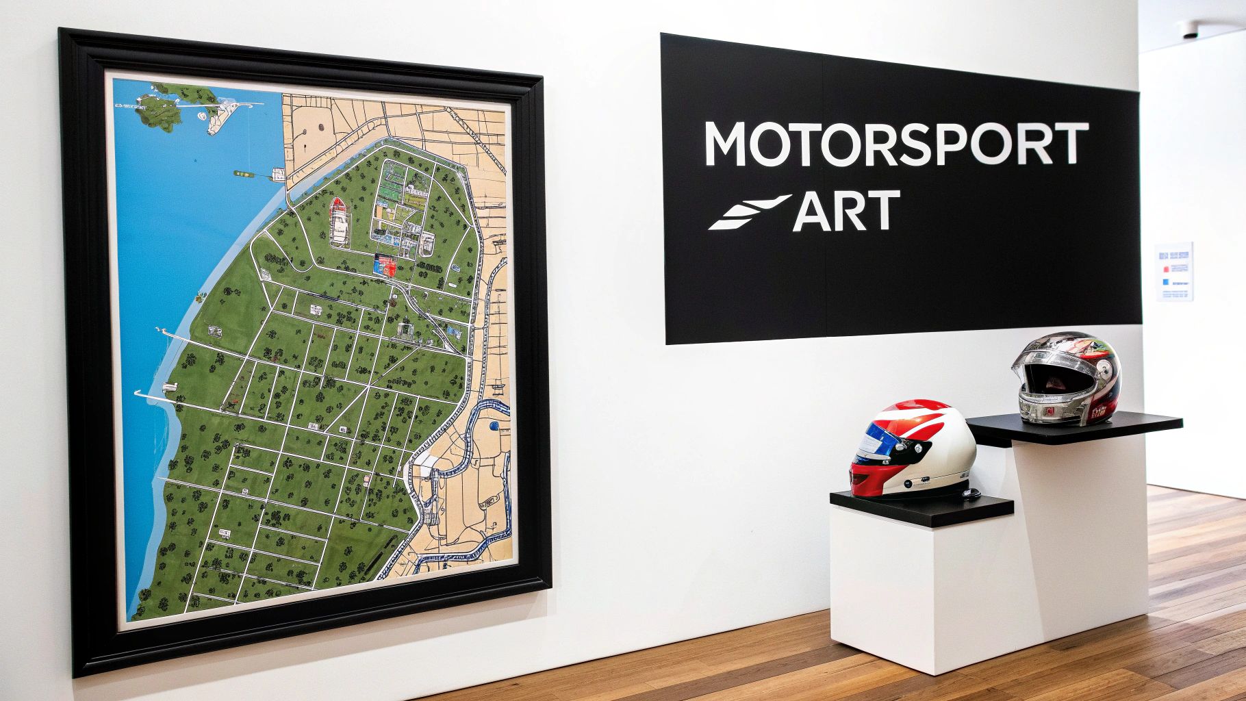 A framed map of a motorsport circuit, a 'MOTORSPORT ART' sign, and two racing helmets on display.