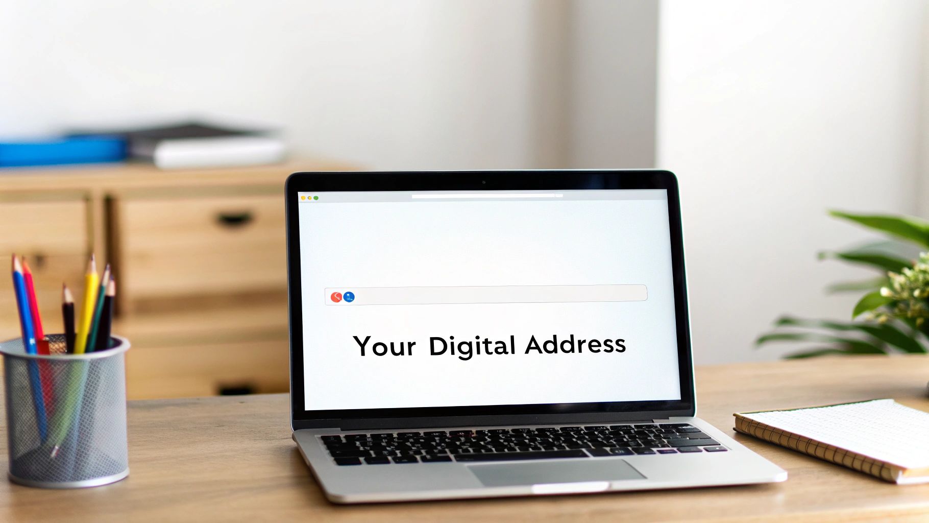 A laptop on a wooden desk displaying a search bar with 'Your Digital Address' on screen.