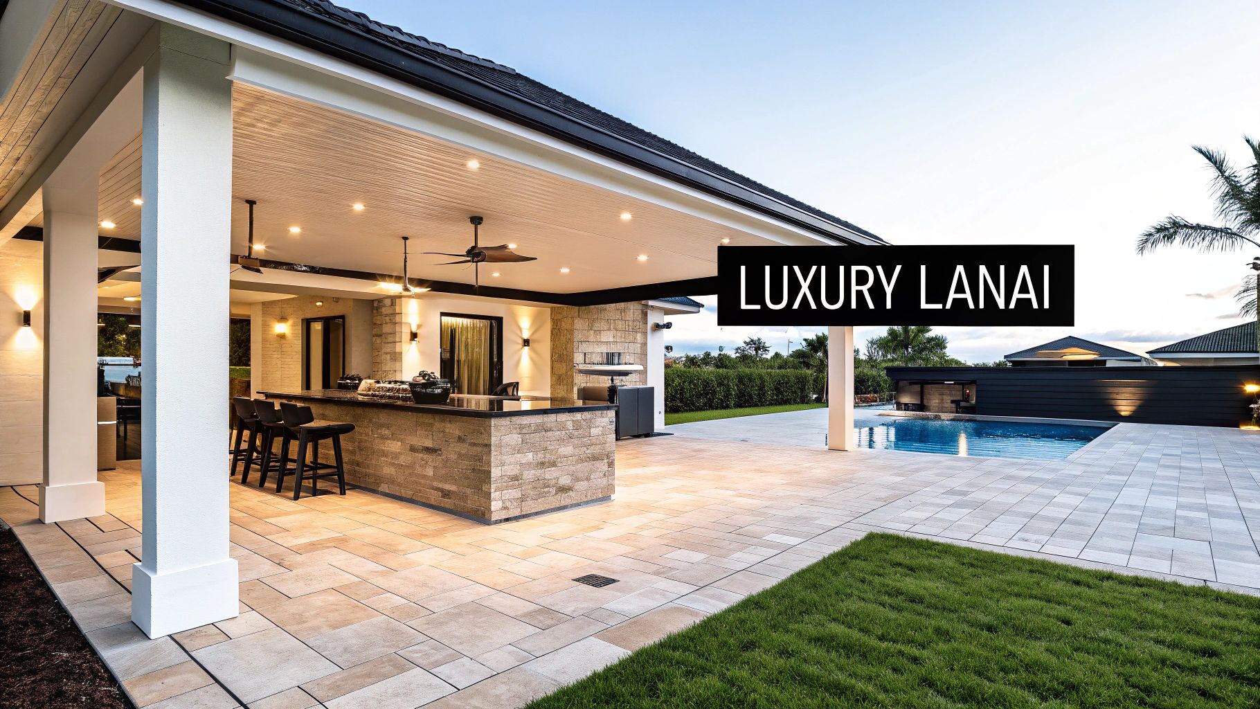 A luxurious lanai with an outdoor kitchen and bar, patio, swimming pool, and green grass.