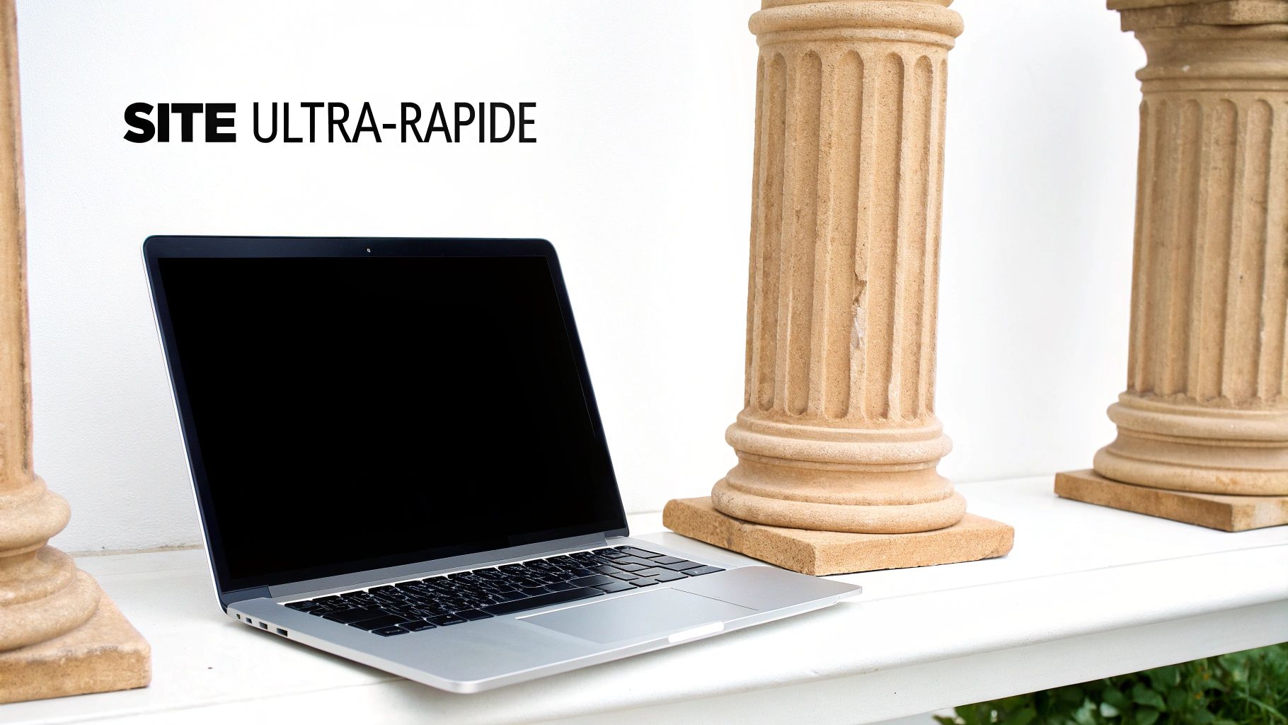 Un ordinateur portable moderne sur un bureau blanc flanqué de colonnes classiques, illustrant un site ultra-rapide.