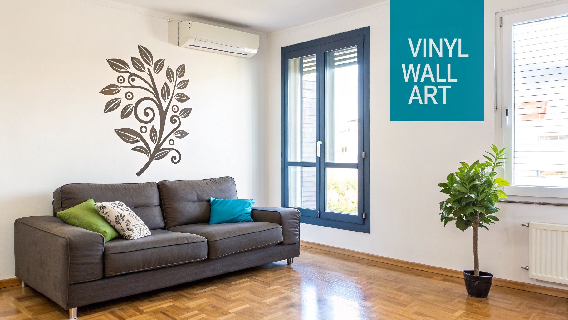 A bright living room with a grey sofa, a large decorative vinyl wall sticker, and a potted plant.
