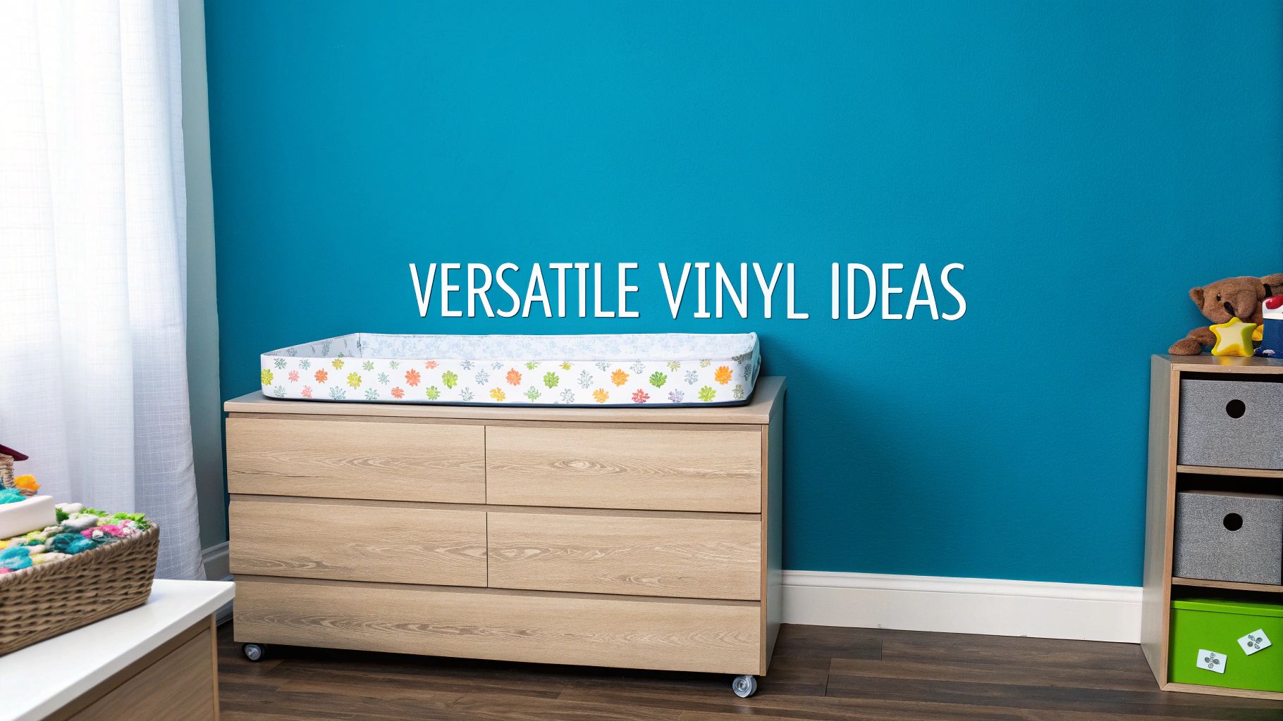 A bright nursery room featuring a wooden dresser with a changing pad and blue wall decor text.