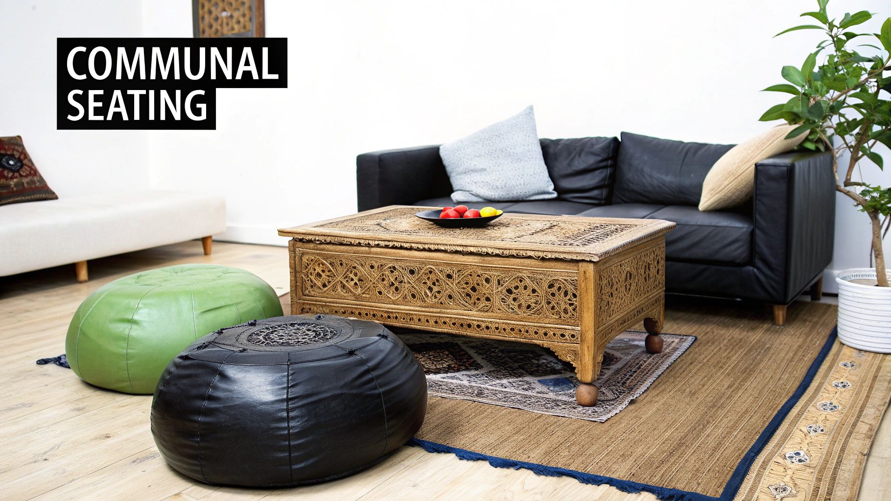 A cozy Moroccan-style communal seating area with a black sofa, carved wooden table, and green and black poufs.