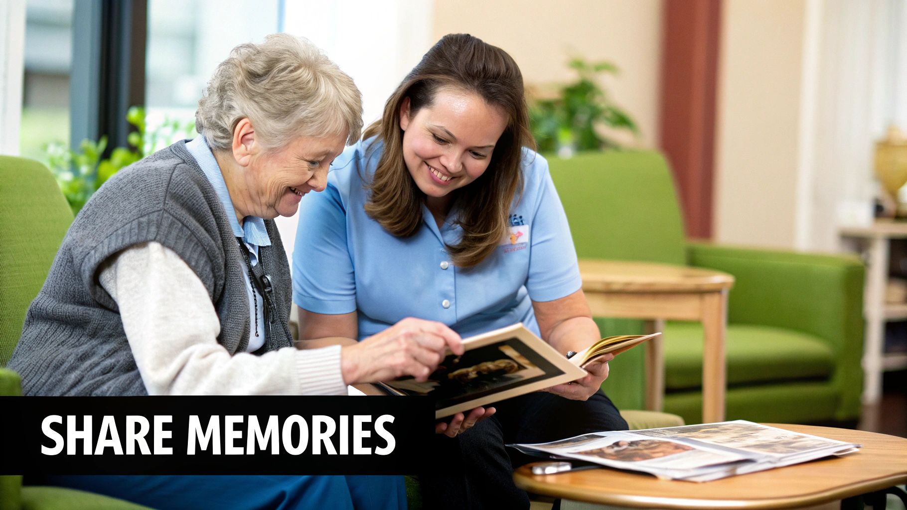 A smiling elderly woman and caregiver share memories by looking at a photo album together.