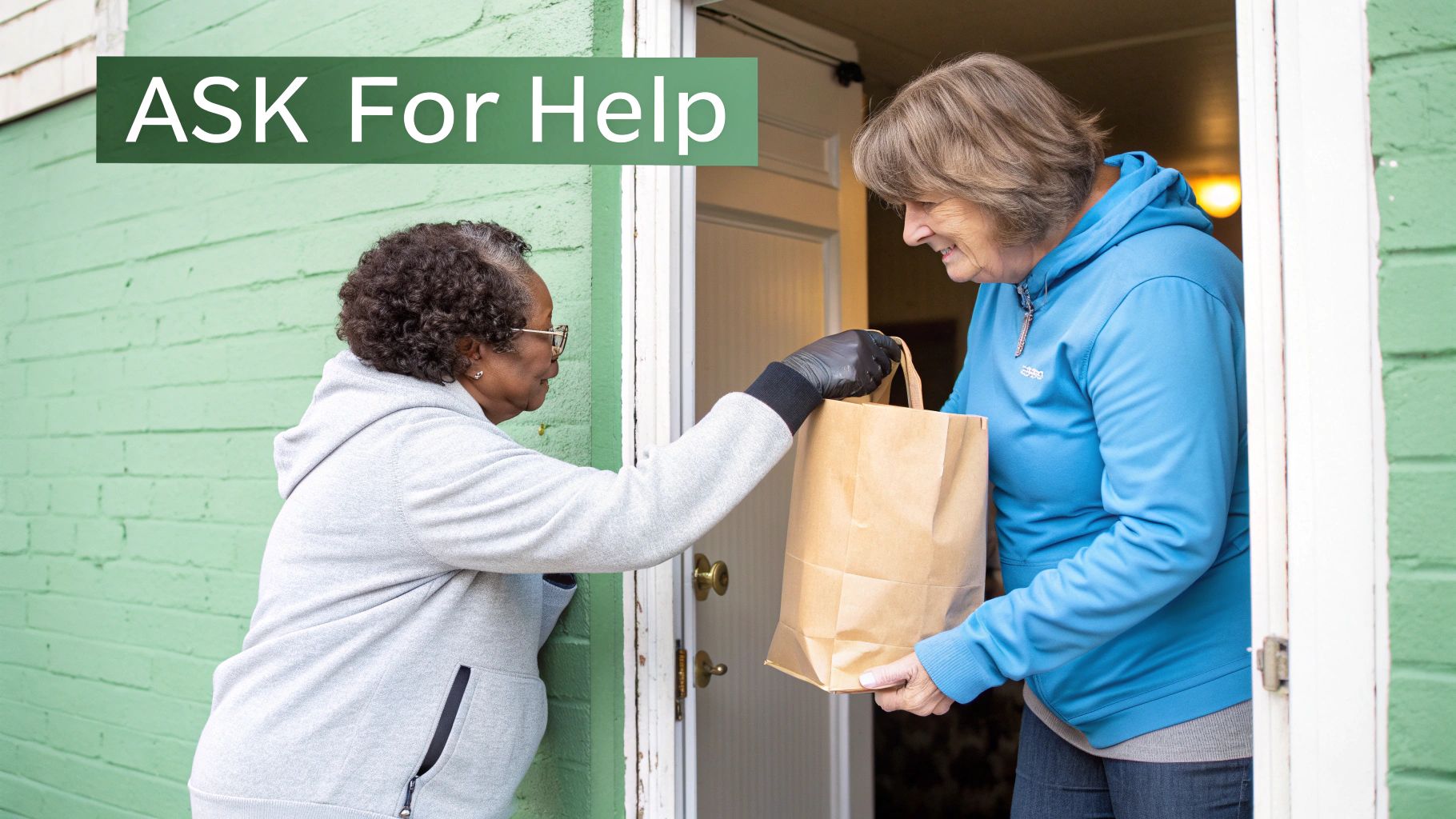 Two women exchange a brown paper bag at a doorway, illustrating community support and asking for help.
