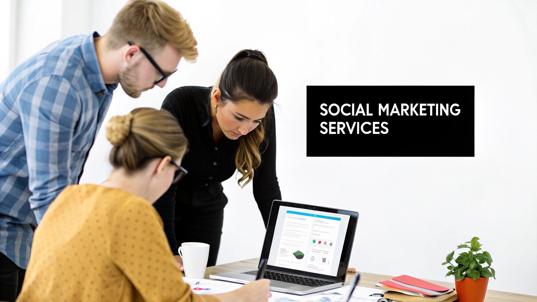 People collaborating on a social media marketing strategy on a digital screen