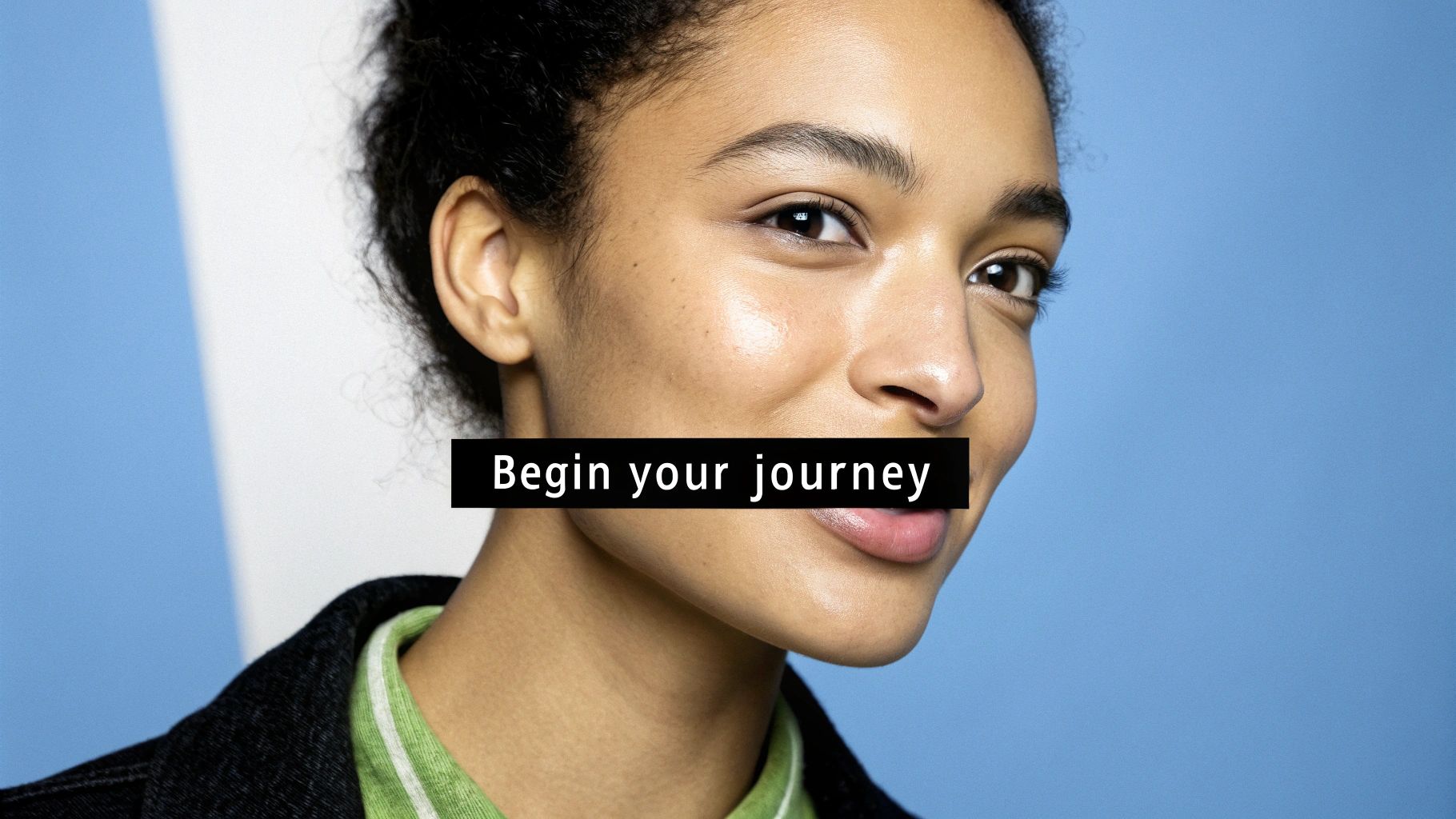 Close-up of a smiling young woman with glowing skin and curly hair, with text 'Begin your journey'.