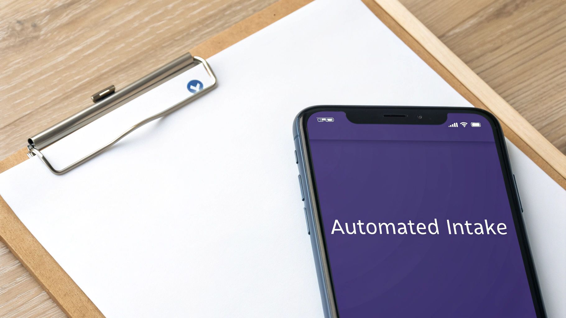 A smartphone displaying 'Automated Intake' next to a clipboard and paper on a wooden surface.
