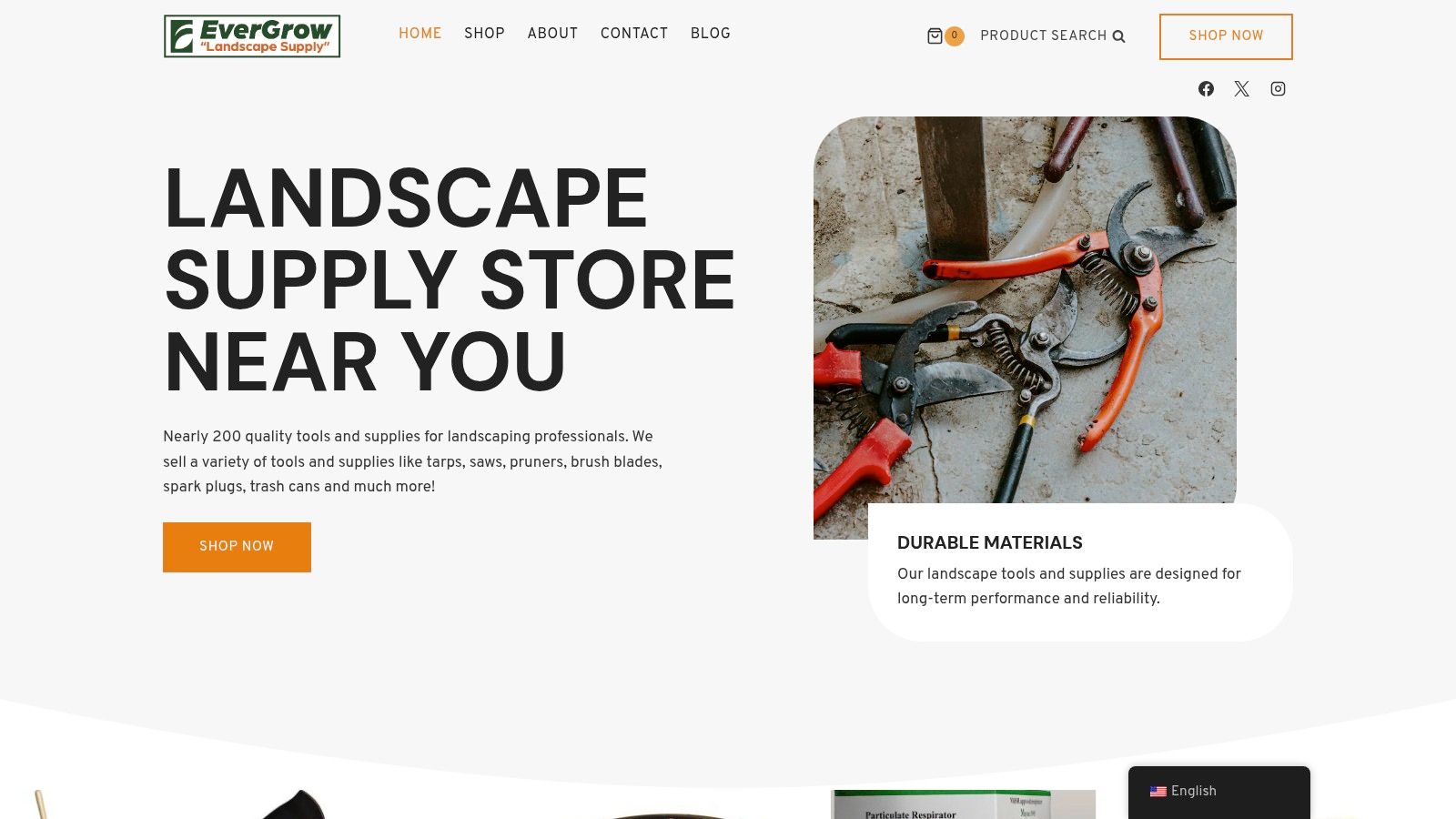 A collection of professional landscaping hand tools including shovels, rakes, and cutting tools, representing a landscape supply store's inventory.