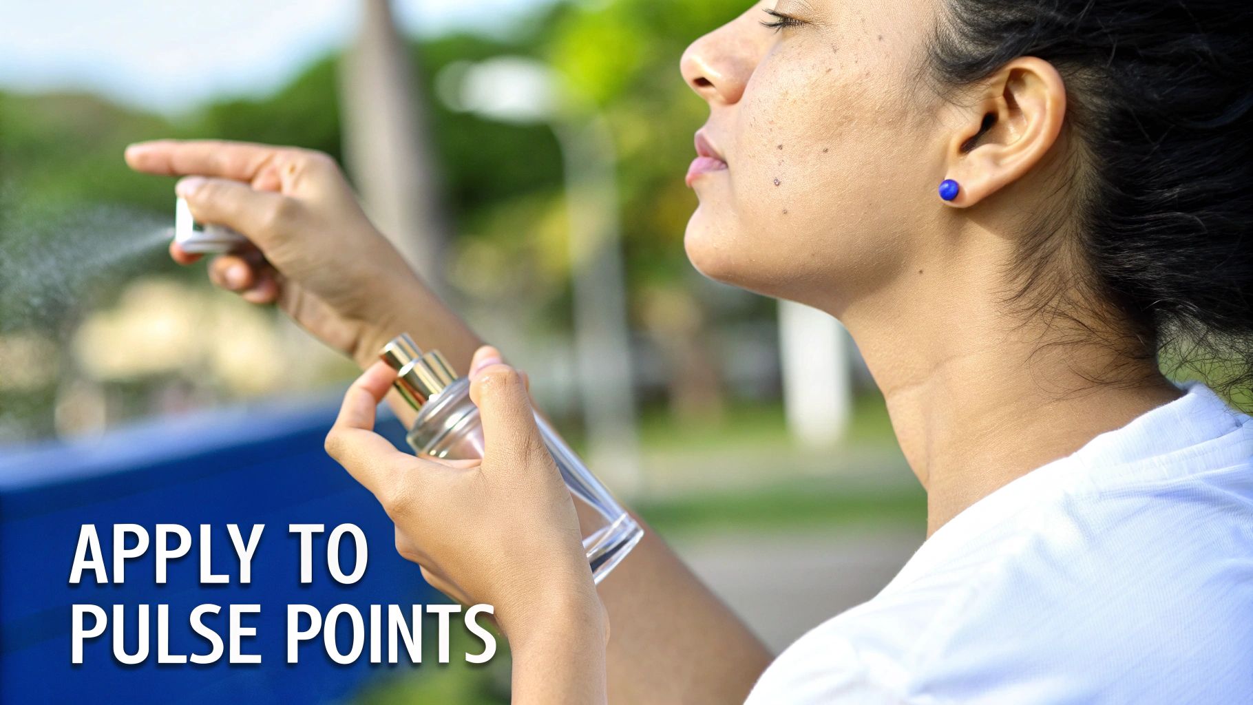 A person applies perfume from a spray bottle, with another bottle in hand, aiming for pulse points.