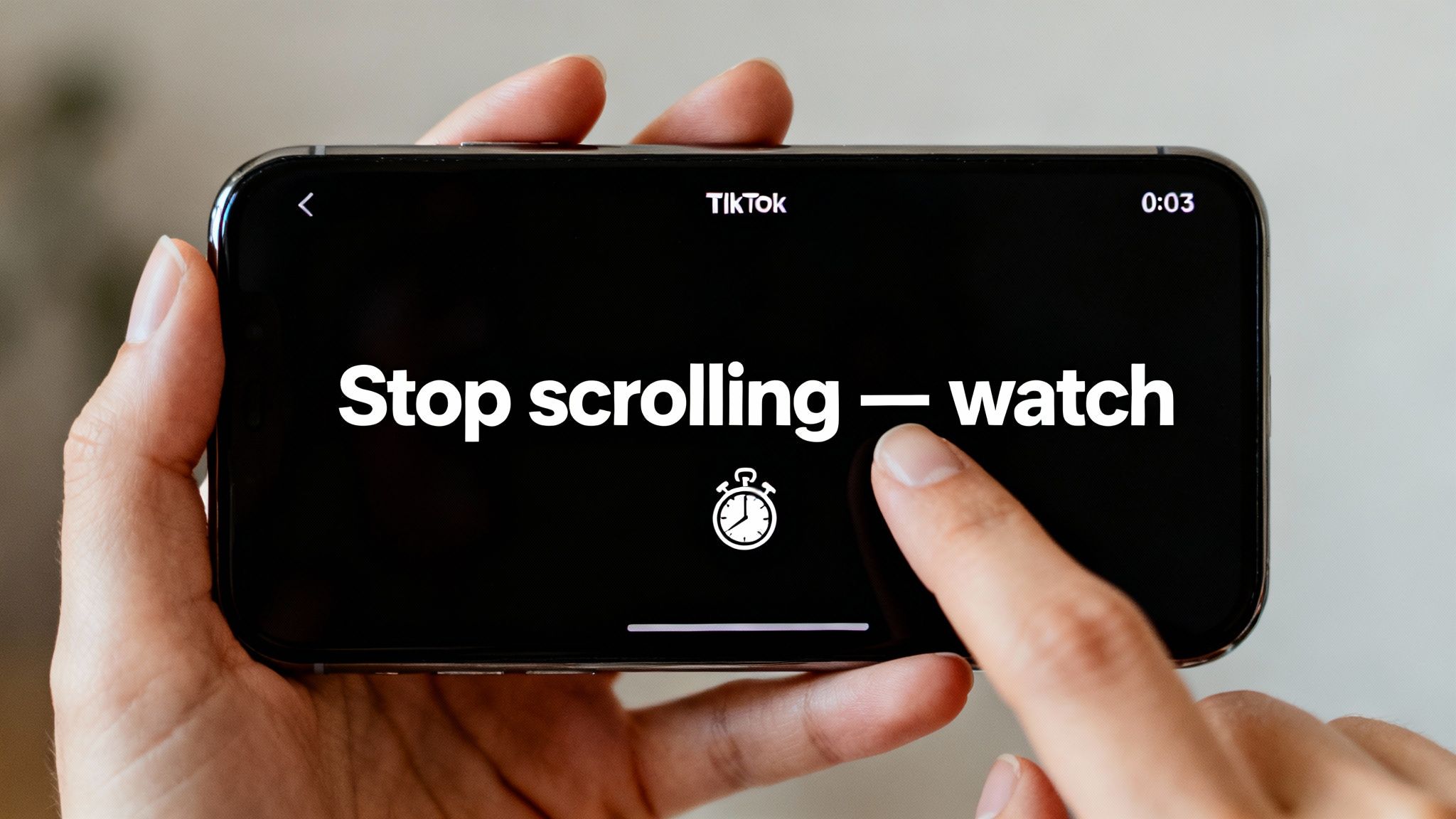 A person holds a smartphone showing a TikTok video with the text 'Stop scrolling — watch' and a stopwatch icon.