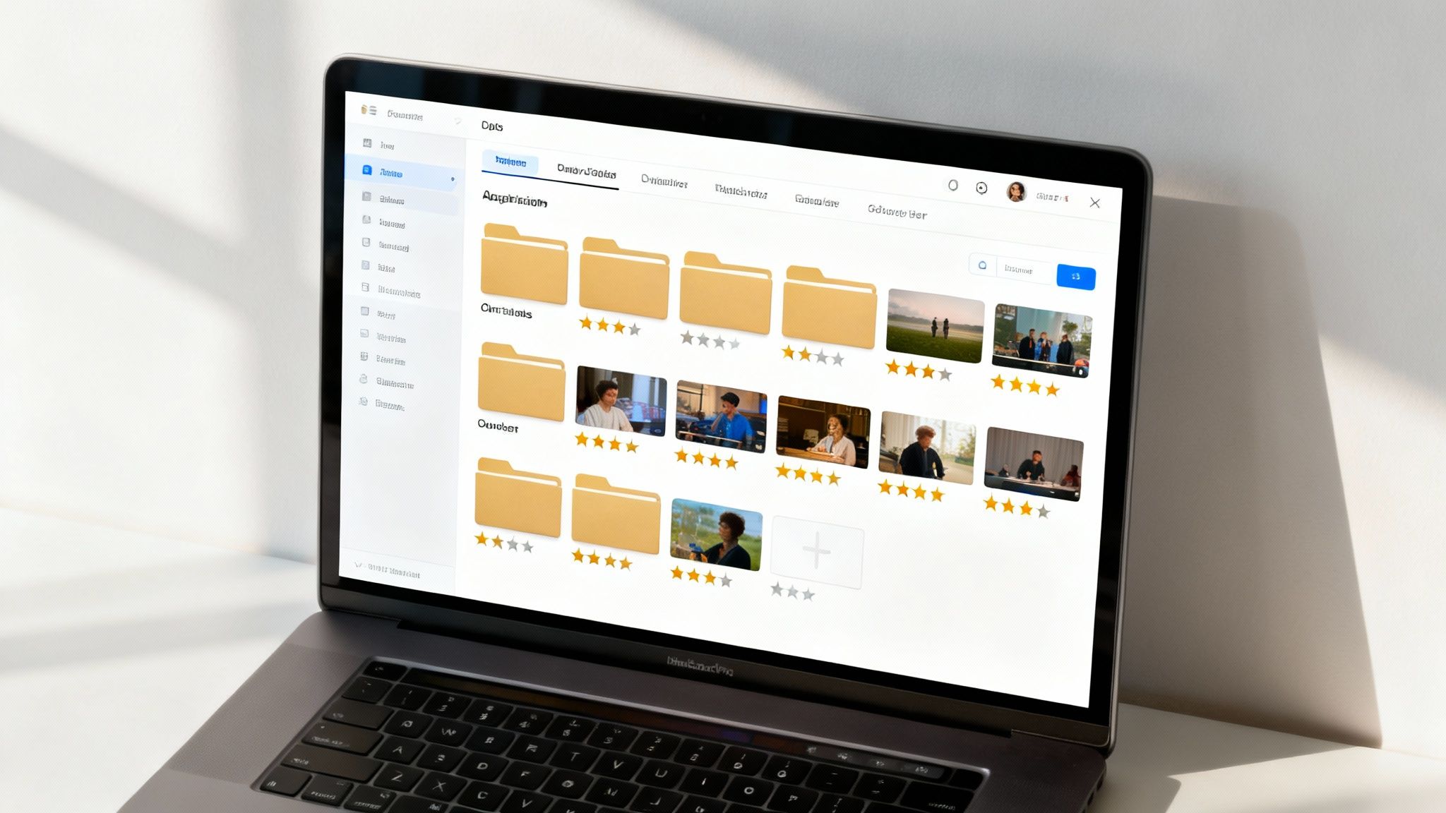 A person's hands organizing clips on a video editing timeline on a laptop screen.