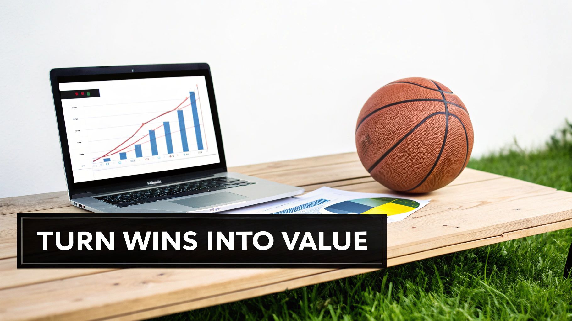 Laptop showing a growth chart, basketball, and documents on a wooden table outdoors, with 'TURN WINS INTO VALUE' banner.