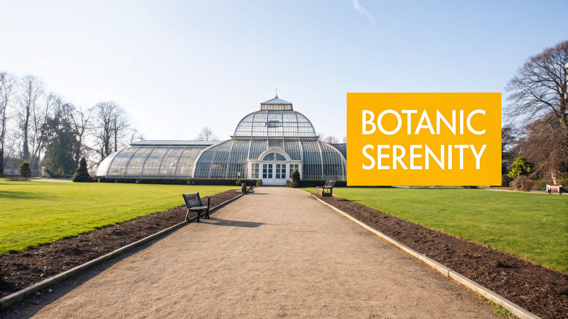 A grand glass conservatory building, likely a palm house, at the end of a gravel path in a sunny park.