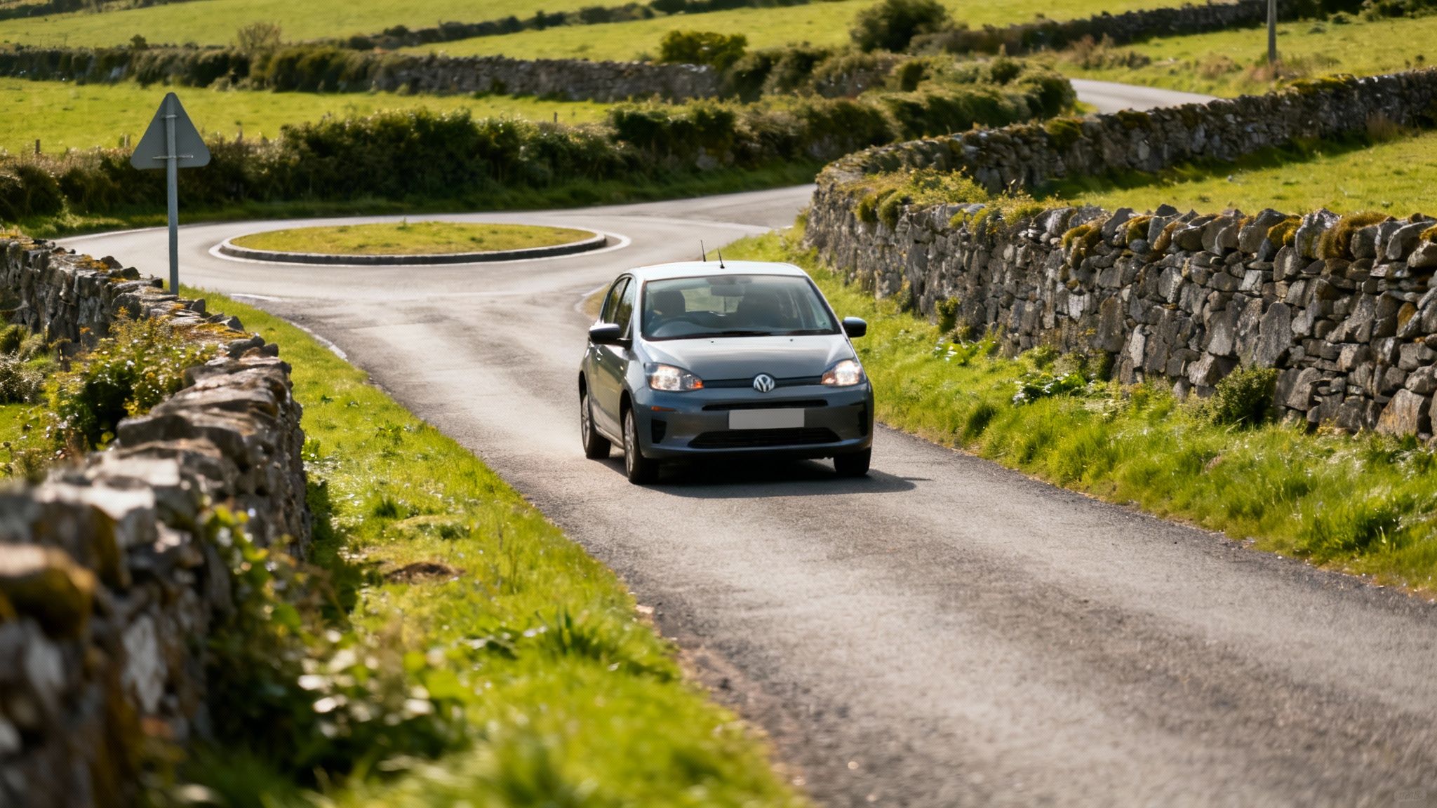 A car driving on a narrow,winding road through the green Irish countryside