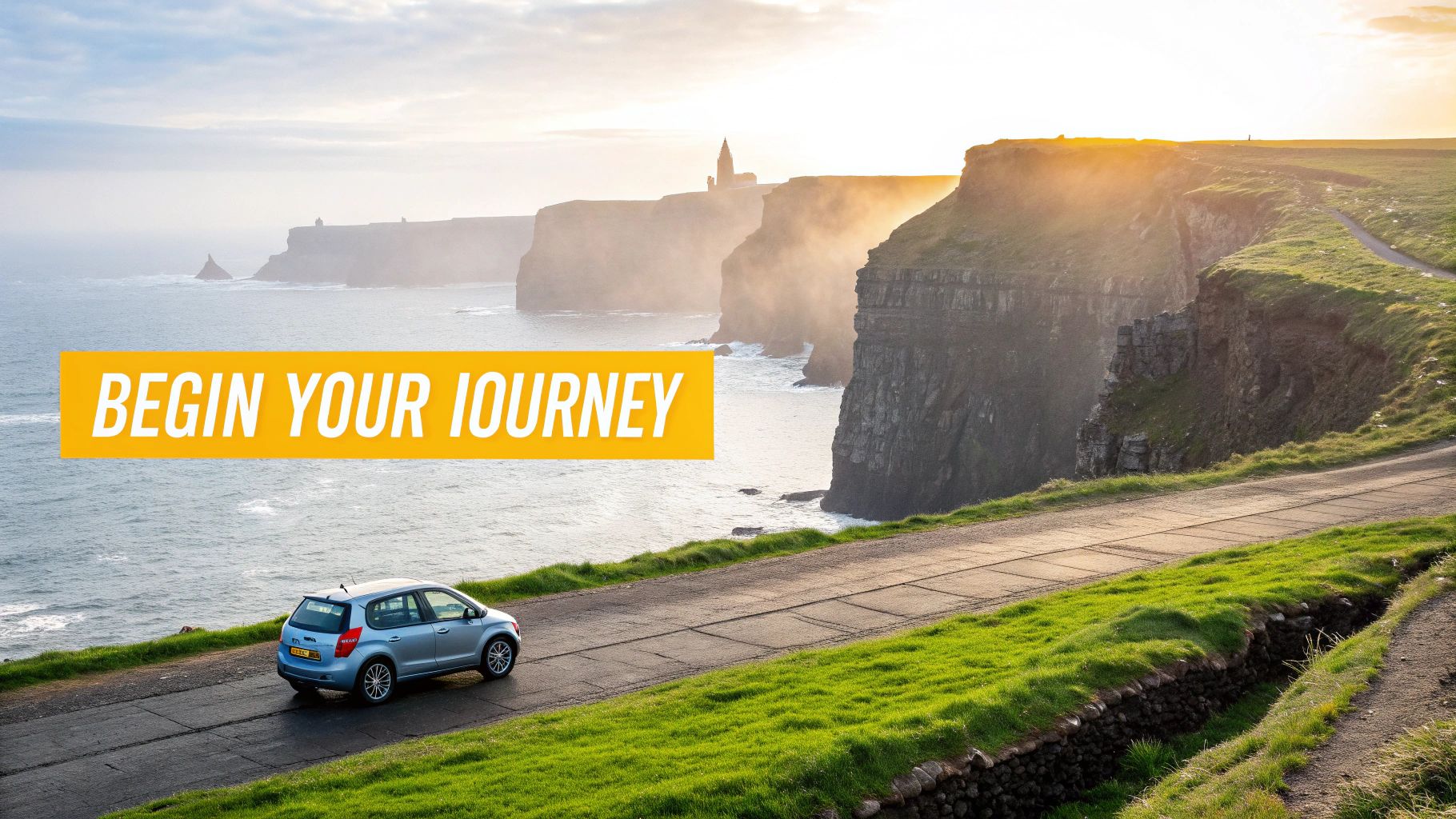 Your Guide to Driving in Eire and Exploring Ireland by Car 3 A blue car drives along a scenic coastal road next to majestic cliffs and the ocean at sunset.