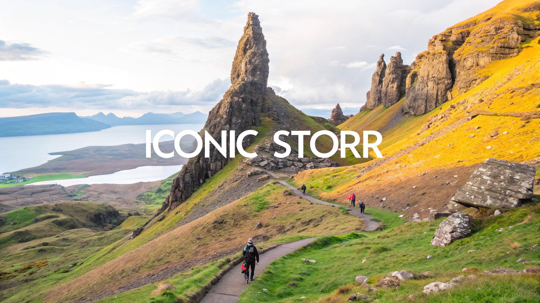 Panoramic view of the iconic Old Man of Storr in Scotland with hikers on a winding path.