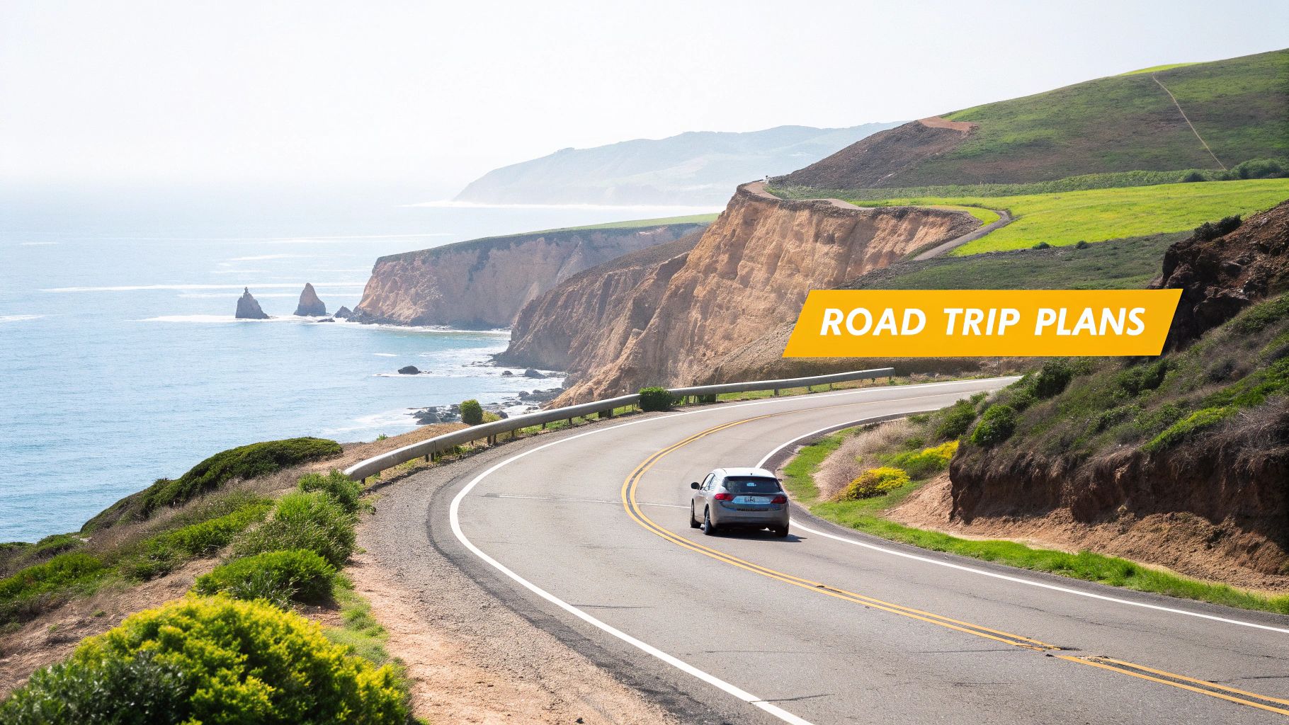 A car drives along a winding coastal road with ocean views, green hills, and dramatic cliffs.