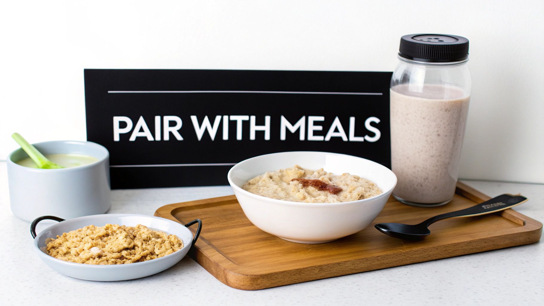 A bowl of oatmeal with fruit and a scoop of creatine powder on the side.