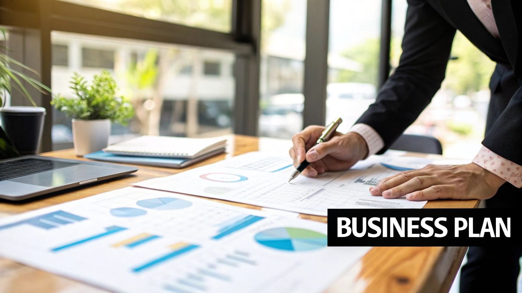 A person writing in a notebook, symbolizing the process of structuring a business plan.