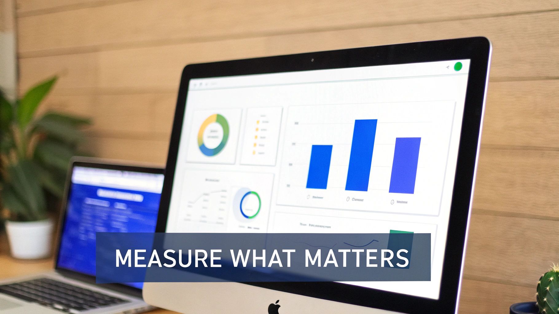 A desktop computer and laptop displaying data analytics dashboards with charts, graphs, and the text 'Measure What Matters'.