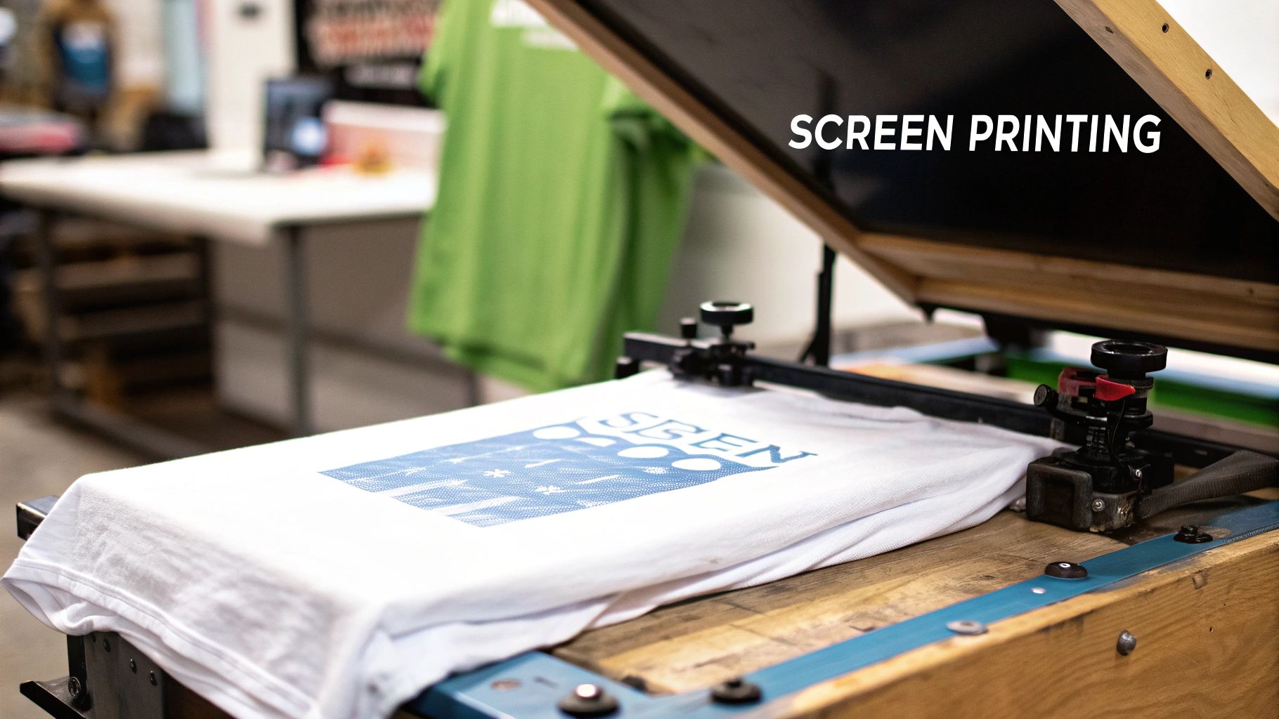 Person using a squeegee to apply ink during the screen printing process