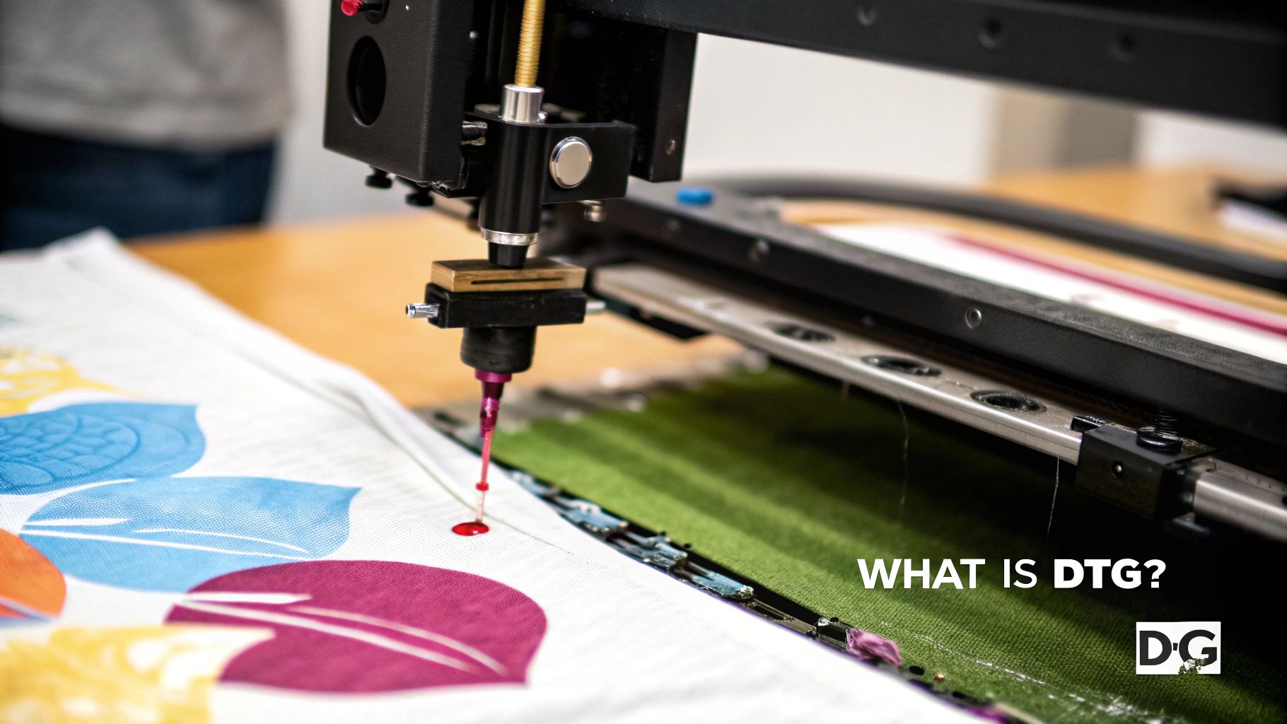 A DTG printer head applying a colorful design onto a white t-shirt.