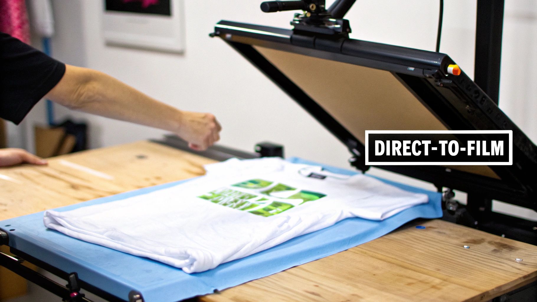A DTF printer in action, showing a colorful design being printed onto a special film roll.