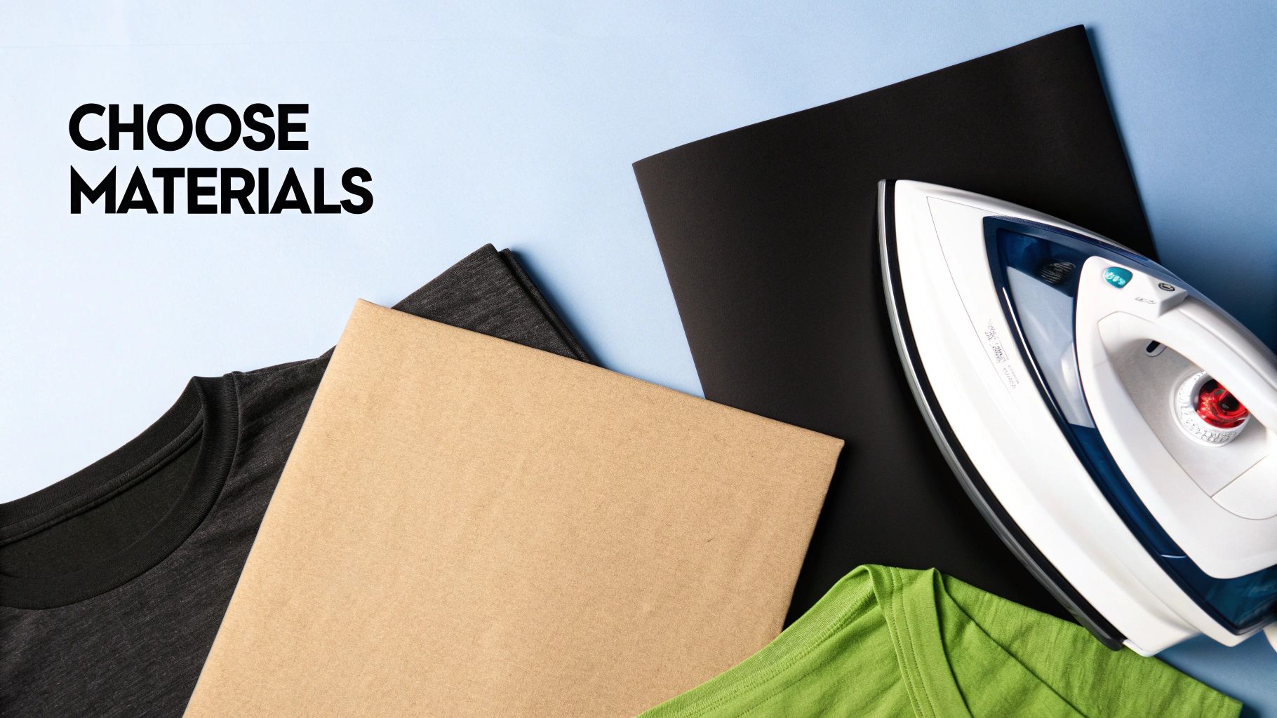 A selection of different colored t-shirts, transfer papers, and a heat press machine.