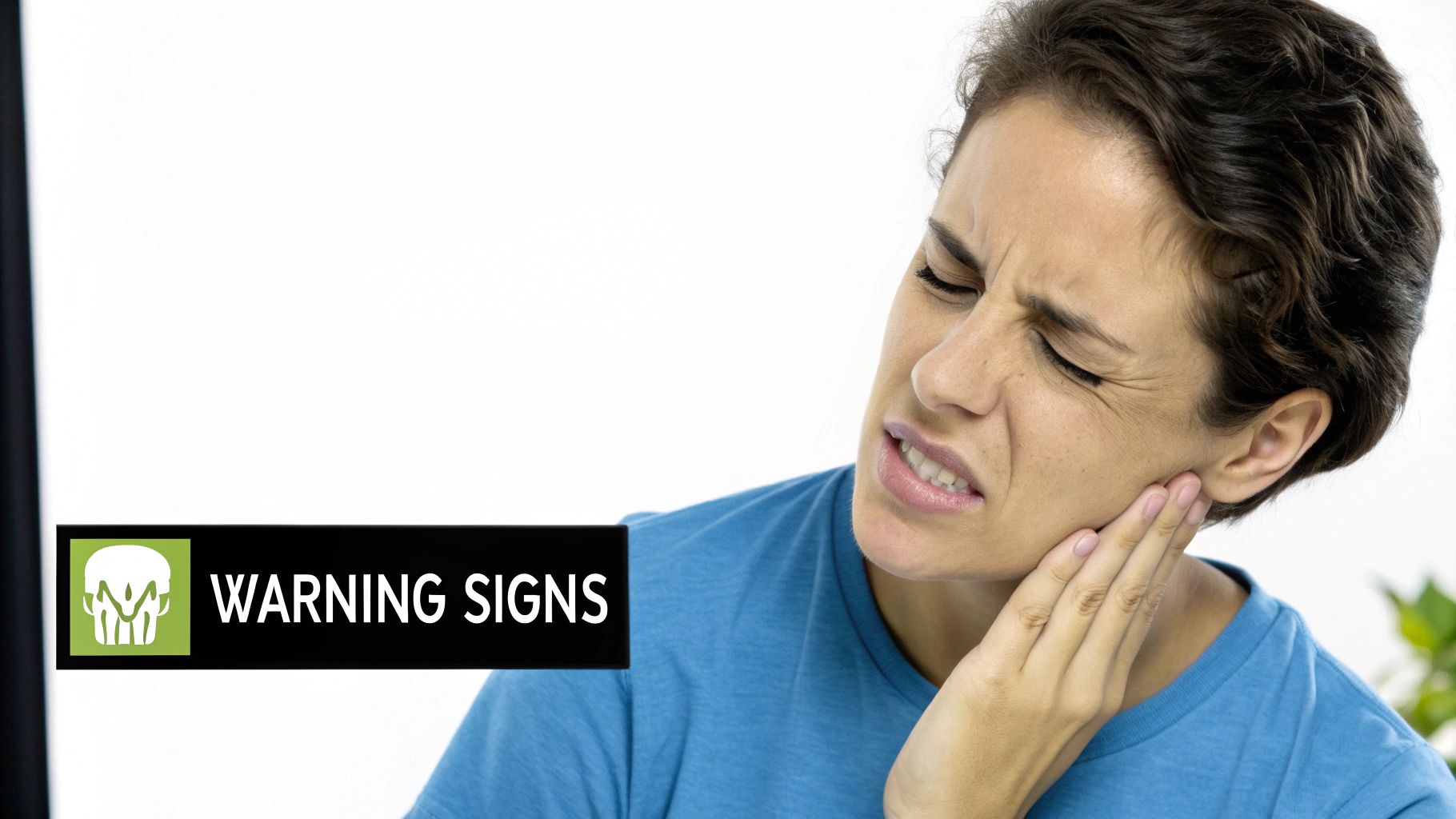 A person examining their teeth and gums in the mirror, looking for signs of dental health issues.