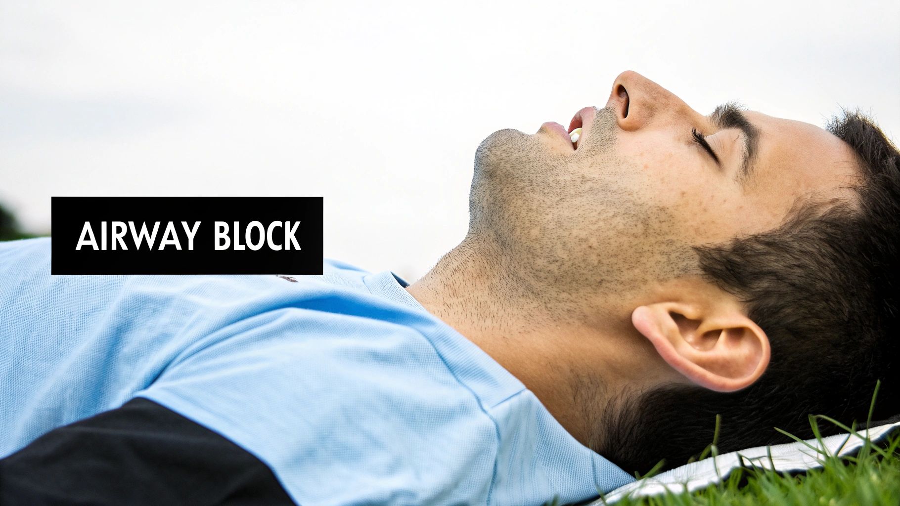 A man lying down with his head tilted back, mouth open, and text 'AIRWAY BLOCK'.