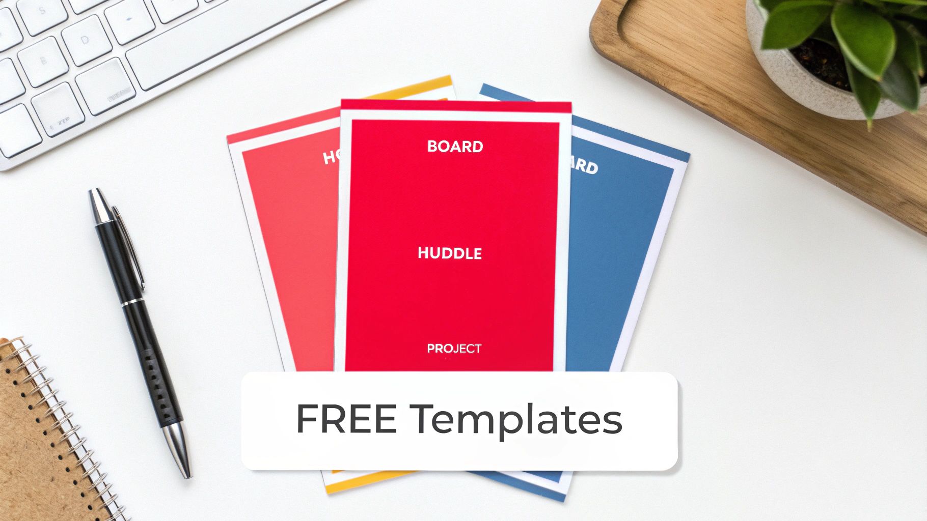 Flat lay of a clean desk with a keyboard, pen, plant, and colorful 'FREE Templates' for projects.