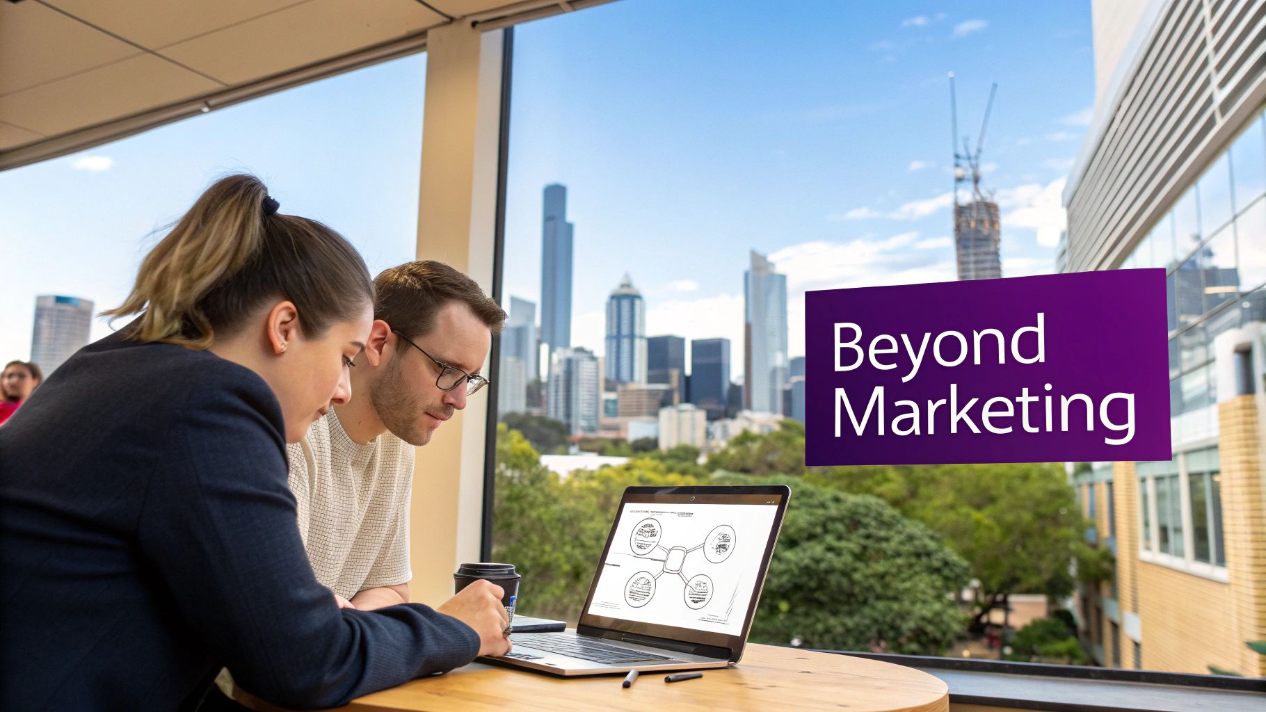 Two professionals collaborate over a laptop with a city skyline view and 'Beyond Marketing' text overlay.