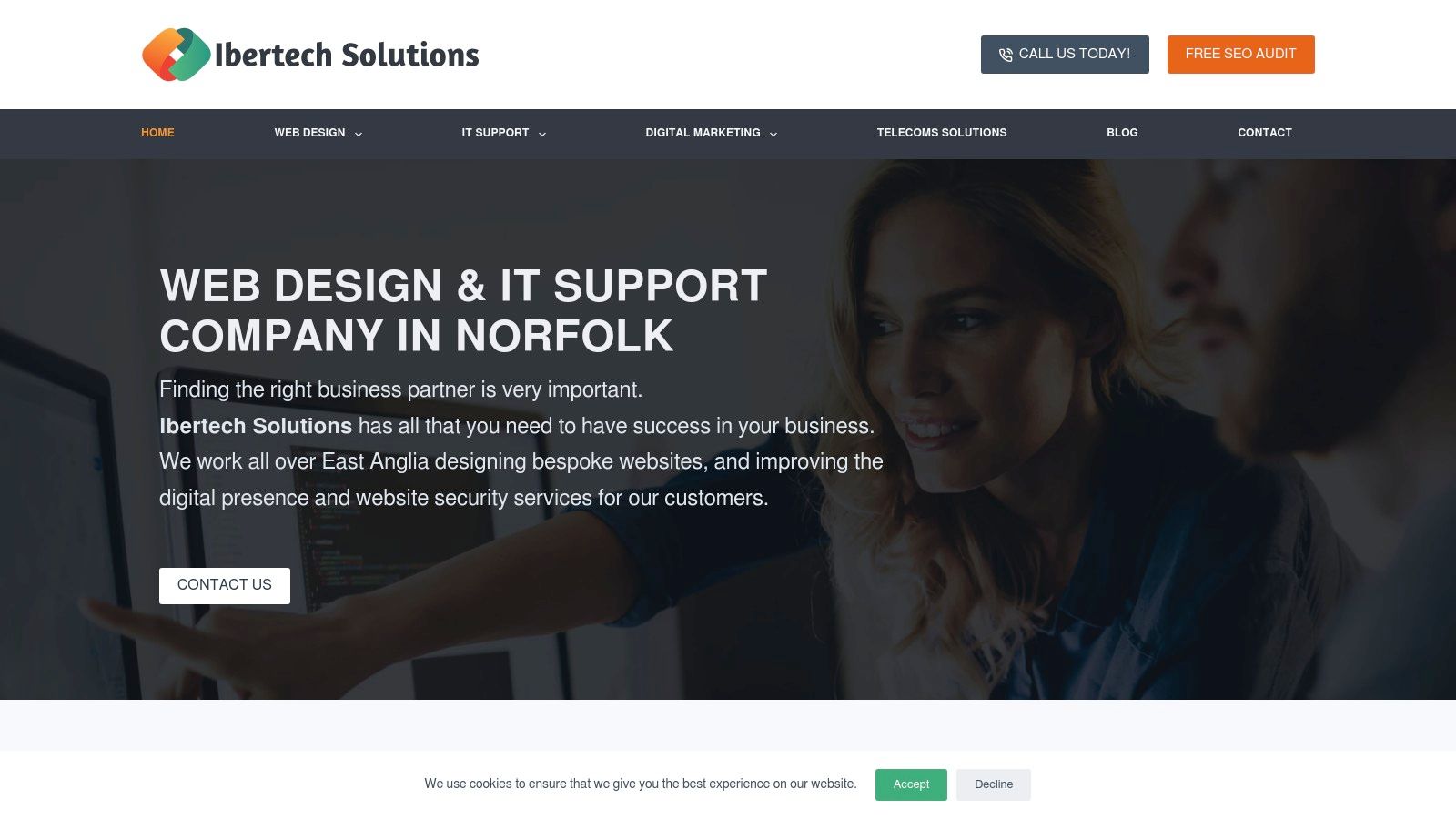 A professional business website homepage displayed on a laptop, illustrating Ibertech Solutions' web design and hosting capabilities.