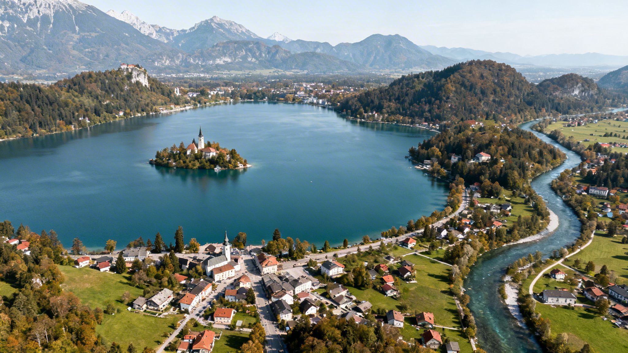 Aerial view of Lake Bled, Slovenia, featuring the island church, castle, and surrounding town.