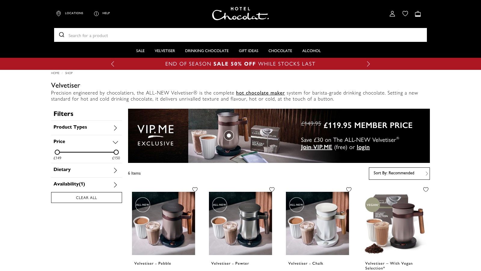 A stylish, copper-coloured hot chocolate machine from Hotel Chocolat, The Velvetiser, stands on a kitchen counter next to a bag of chocolate flakes.