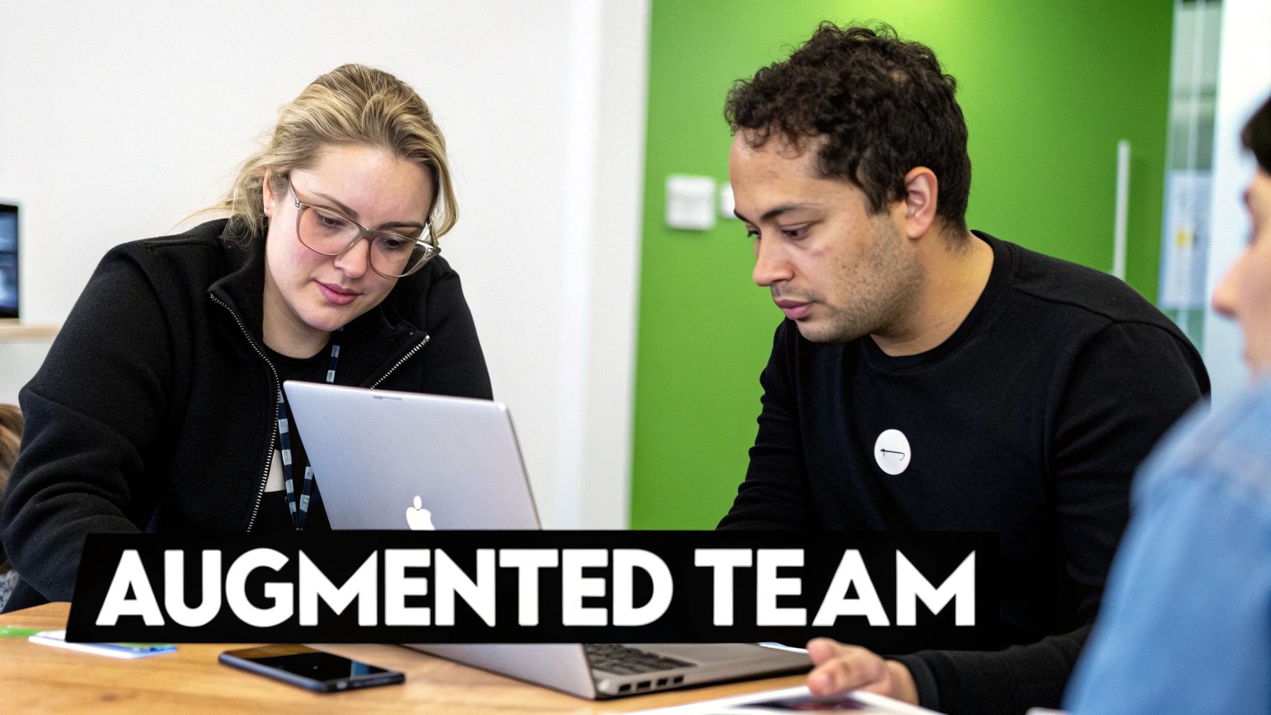 A team collaborating around a table, illustrating the integration of augmented staff.